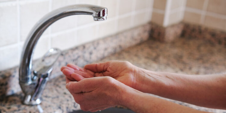 Middle aged woman hands and water shortage.Climate crisis.Affected of global warming made climate change. Drought concept.
