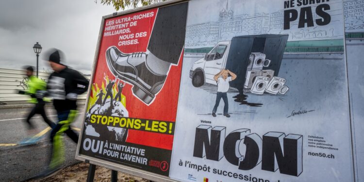 Voting posters in favor and against an initiative to tax the super-rich to help to finance the country's effort against climate change is seen in a street in Geneva, on November 25, 2025. The Swiss will vote on November 30, 2025 on replacing men's current military service requirement with a compulsory civic duty for all, with backers and opponents alike claiming to be championing women's rights. As part of Switzerland's direct democratic system, voters will also be weighing in on whether to slap new taxes on the super-rich to help finance the country's effort against climate change. (Photo by Fabrice COFFRINI / AFP)