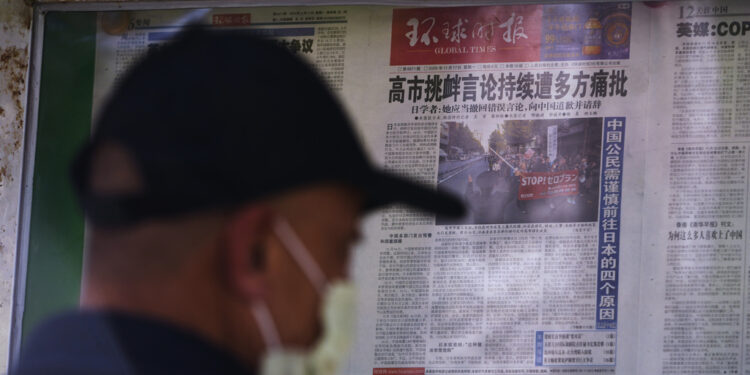 FILE - A man reads local newspapers reporting on Japanese Prime Minister Sanae Takaichi's recent remarks on Taiwan, at a newsstand in Beijing, on Nov. 17, 2025. (AP Photo/Andy Wong, File)