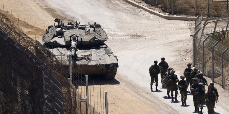 Israeli troops patrol the border fence with Syria near the Druze village of Majdal Shams in the Israel-annexed Golan Heights on July 23, 2025. Israeli troops on July 16 sought to control crowds and prevent Druze from crossing the security fence with Syria, with soldiers in the occupied Golan Heights firing teargas to keep order along the heavily fortified frontier after dozens of people tried to cross over amid deadly violence in Syria's southern Druze heartland that prompted Damascus to send in government forces. (Photo by Jalaa MAREY / AFP)