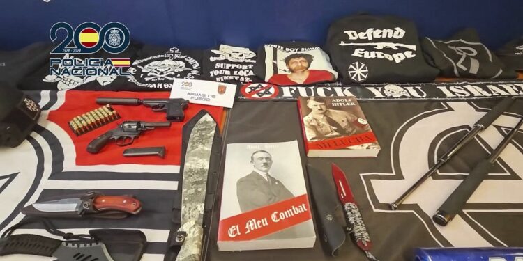 In this still image from video released on December 1, 2025 by the Spanish National Police material confiscated during operations against a Spanish branch of The Base, a neo-nazi supremacist organization, is displayed. Spanish police arrested three suspects including the suspected leader of The Base in Spain. (Photo by Handout / Spanish National Police / AFP) / RESTRICTED TO EDITORIAL USE - MANDATORY CREDIT "AFP PHOTO / POLICIA NACIONAL" - HANDOUT - NO MARKETING NO ADVERTISING CAMPAIGNS - DISTRIBUTED AS A SERVICE TO CLIENTS