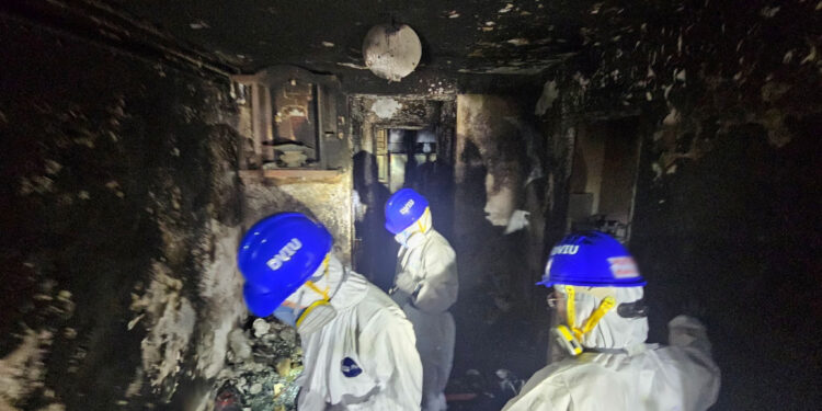 Members of the Hong Kong Police Force's Disaster Victims Identification Unit (DVIU) operate during a search operation at the Wang Fuk Court housing complex, in Hong Kong, China, November 30, 2025. Hong Kong Police Force/Handout via REUTERS THIS IMAGE HAS BEEN SUPPLIED BY A THIRD PARTY. NO RESALES. NO ARCHIVES. MANDATORY CREDIT.