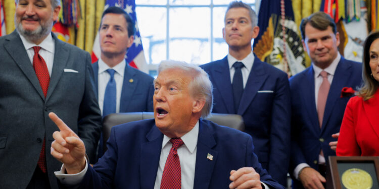 U.S. President Donald Trump points during the announcement of new fuel economy standards, in the Oval Office at the White House in Washington, D.C., U.S., December 3, 2025. REUTERS/Brian Snyder