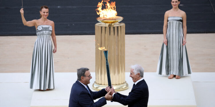 Winter Olympics - 2026 Milano-Cortina Winter Olympic Flame handover ceremony - Panathenaic Stadium, Athens, Greece - December 4, 2025 President of the Milano Cortina 2026 Organizing Committee, Giovanni Malago and President of the Hellenic Olympic Committee, Isidoros Kouvelos hold the Olympic flame during the ceremony REUTERS/Louisa Gouliamaki     TPX IMAGES OF THE DAY