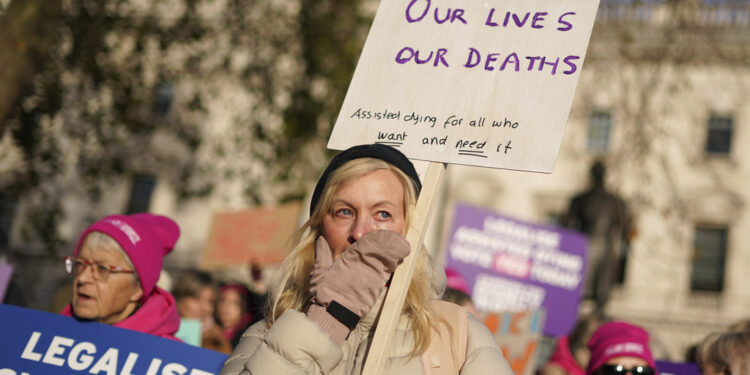 Pro legal assisted dying supporters demonstrate in front of Parliament in London, Friday, Nov. 29, 2024 as British lawmakers started a historic debate on a proposed to help terminally ill adults end their lives in England and Wales.(AP Photo/Alberto Pezzali)